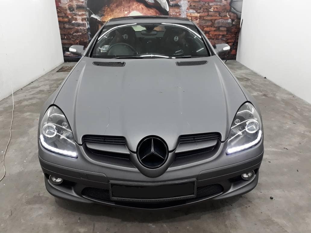 Charcoal grey SLK with gloss black roof.