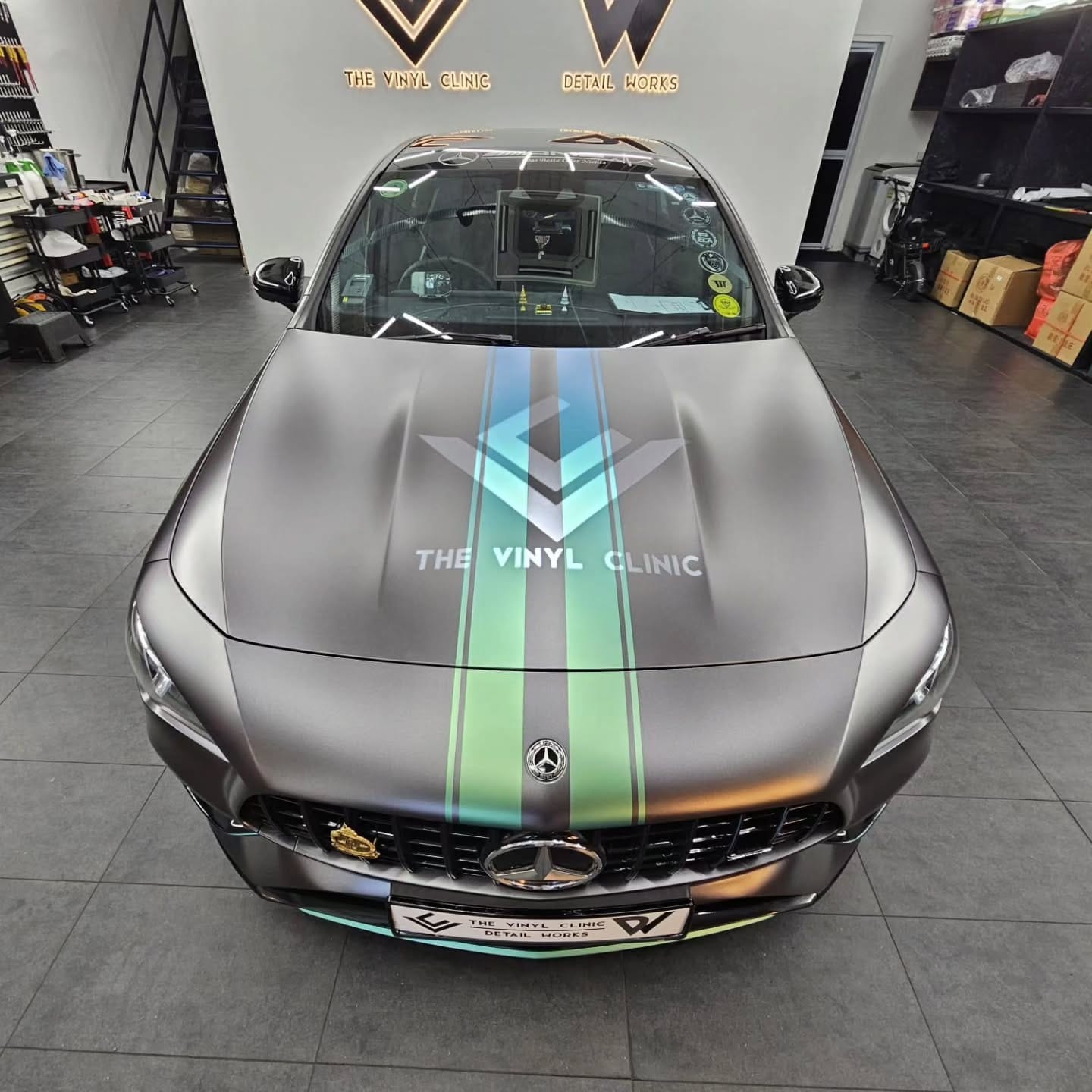 Matte dark grey with custom racing stripes.