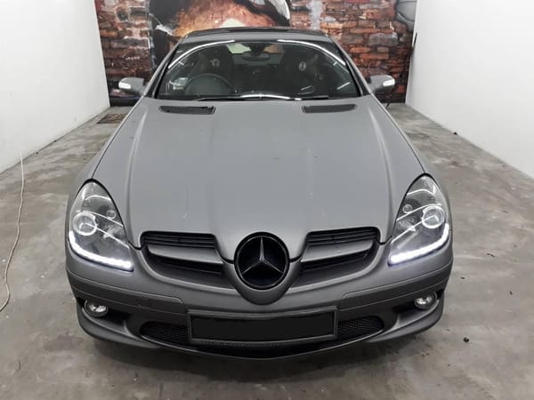 Charcoal grey SLK with gloss black roof.
