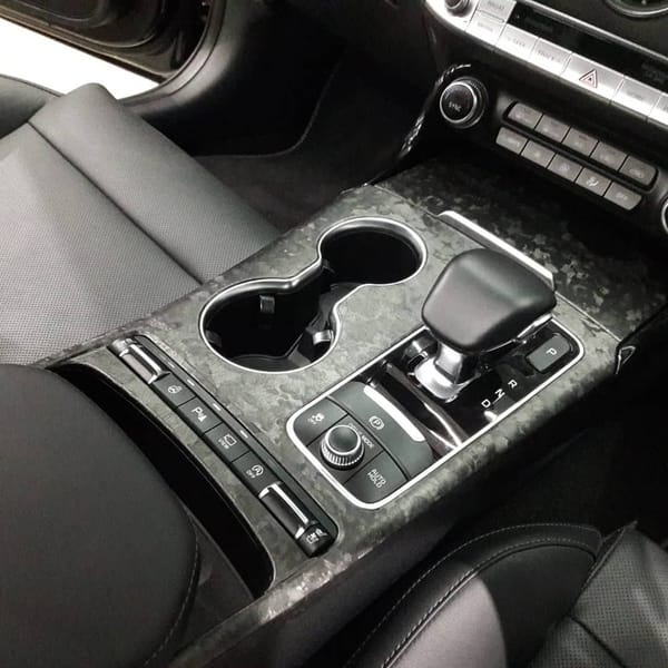 Forged carbon wrap. Yes, not the printed type.