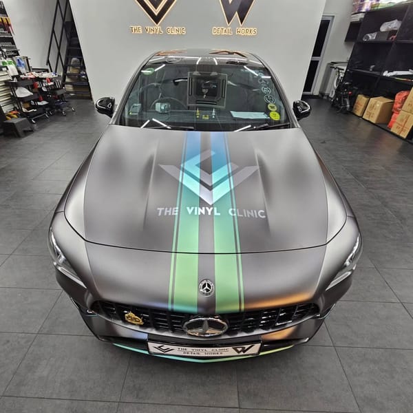 Matte dark grey with custom racing stripes.